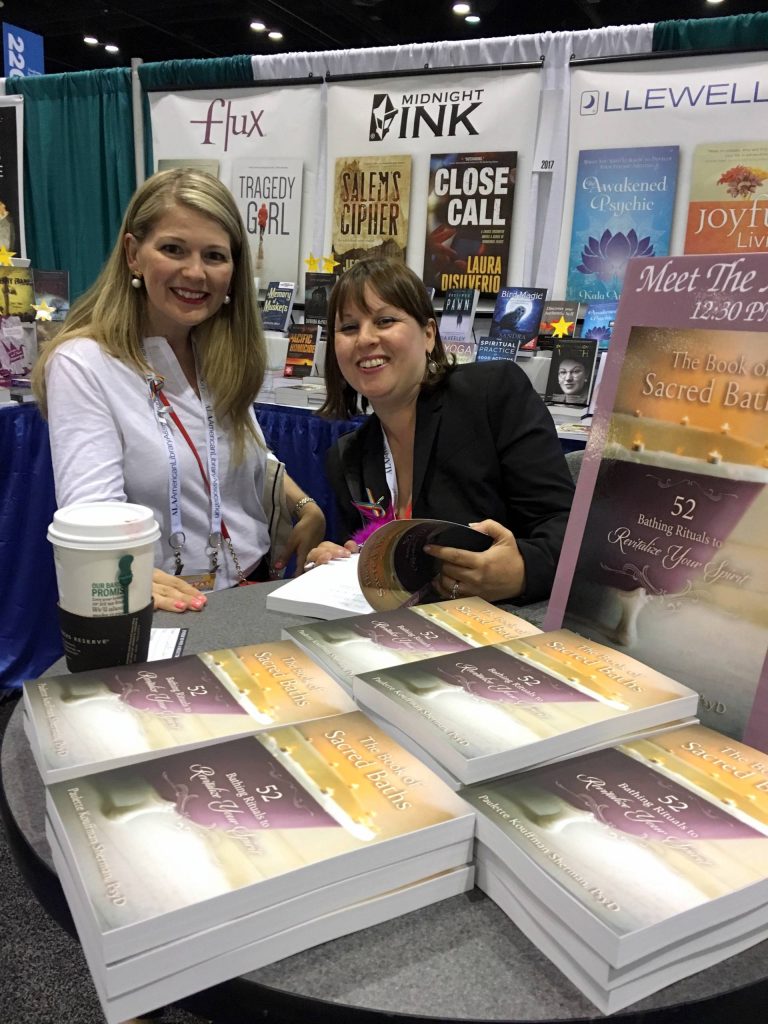 Paulette chatting with bath lover over her new book "The Book of Sacred Baths" at ALA Orlando event.